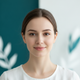 Close-up portrait of a serene young adult woman smiling gently, conveying calm and mental clarity.